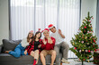 © Odua Images - asian people video calling friend at christmas day