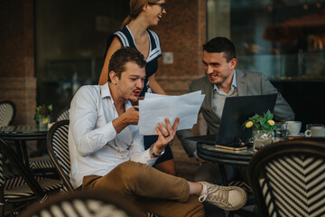 Businesspeople discussing ideas and documents during an outdoor cafe meeting, using digital devices. A team collaborating in a relaxed yet professional setting.