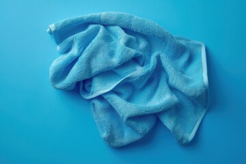 Soft blue towel crumpled on a bright blue surface in a serene setting