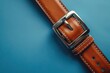 © Your Choice - Brown leather belt on blue background with silver buckle