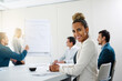 © FotoPush/peopleimages.com - Portrait, smile and business woman in meeting with team for coworking in corporate office. Face, happy and professional sales manager in presentation for budget report, training information and data