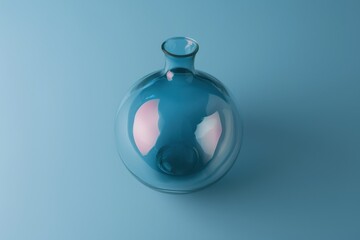 Poster - Transparent glass vase on a soft blue background highlighting its curved shape and reflections