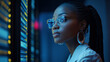 © Majce - African American female IT specialist under blue lighting, black cyber security analyst.