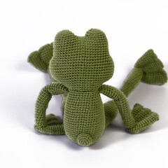 Wall Mural - background white isolated frog amigurumi doll sitting