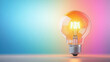 © Nano Photos - A glowing light bulb against a vibrant, colorful gradient background symbolizes creativity, innovation, and bright ideas in a modern, artistic setting.