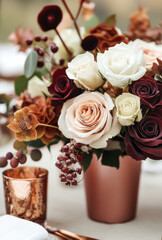 Wall Mural - warm and inviting fall wedding table setting with rich, autumn colors of terracotta, rust orange, burgundy, brown, and gold. The centerpiece is an elegant arrangement featuring roses 