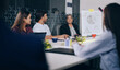© Raushan_films - Indian Asian happy older female old elder lady boss young adult girls boy male expert staff group team man agent sitting talk gossip share new project plan good news ideas office job work place