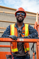 Construction worker wearing safety gear smiling on construction site