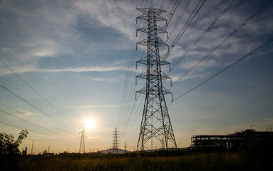 Overhead line pylons, high voltage pylons. Power transmission towers and lines at sunset. A shot of high voltage electric transmission tower, also known as electricity pylon.