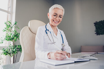 Sticker - Photo of aged woman qualified doctor pen write notepad wear white coat workplace office indoors