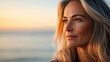 © Wan - A serene profile of a older woman with flowing hair, gazing thoughtfully into the horizon during a beautiful sunset.