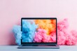 © Jane_S - A laptop displaying vibrant clouds of pink, blue, and orange smoke emerging from the screen, creating a dynamic contrast with the pastel background.