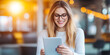 © Jaruwan photo - Smiling woman using tablet in bright, modern setting, showcasing happiness and engagement with technology. warm lighting adds cheerful atmosphere to scene