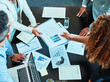 © peopleimages.com - Office, business people and manager with paperwork for meeting, discussion and finance graphs by above. Boardroom, teamwork and employees with document for performance, financial progress and project