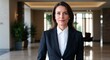 © sevenSkies - Adult French woman in formal suit neutral expression portrait photo office lobby background
