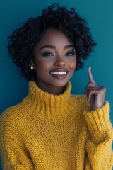 Wall Mural - Young woman in bright sweater gestures playfully against a vibrant blue background