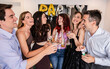 © PintoArt - Group of friends having fun toasting at house party