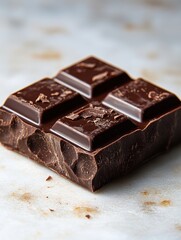 Wall Mural - A single piece of milk chocolate with smooth, shiny surface and crisp edges, isolated on white background 