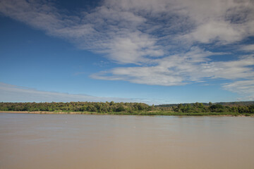 River with mountain reflection under cloudy sky