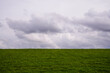 © nuehnenfoto - Norddeich Dike with clouds on the horizon
