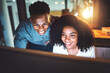 © peopleimages.com - Discussion, computer and happy business people at night in office for project research, planning and website. Corporate, professional and man and woman on pc for teamwork, collaboration and proposal