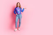 © deagreez - Full body portrait of nice young girl hold empty space ad wear sweater isolated on pink color background