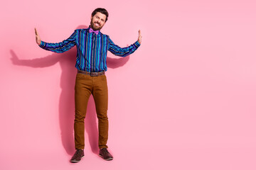 Canvas Print - Full length photo of attractive strong man wear stylish outfit push heavy banner empty space isolated on pink color background