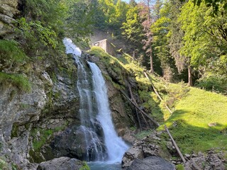 Wall Mural - Giessbach Falls in the eponymous nature park and over Lake Brienz - Giessbachfälle (Giessbachfaelle) im gleichnamigen Naturpark und über dem Brienzersee-Canton of Bern, Switzerland (Schweiz)