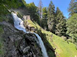 Wall Mural - Giessbach Falls in the eponymous nature park and over Lake Brienz - Giessbachfälle (Giessbachfaelle) im gleichnamigen Naturpark und über dem Brienzersee-Canton of Bern, Switzerland (Schweiz)