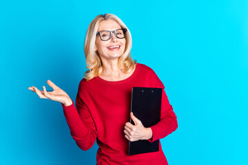 Canvas Print - Photo portrait of lovely pensioner lady hold paperholder laugh dressed stylish red garment isolated on blue color background