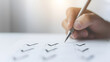 © A2Z AI  - Hand Holding a Pen Over a Checklist – Task Management and Productivity Concept