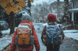 © Nataliya - Two children with backpacks are walking to school along a suburban street. It is winter weather, it is snowing.