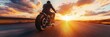 © olegganko - Rider cruising on a motorcycle at sunset along a deserted highway in the countryside
