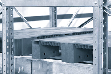 Fototapete - Empty red plastic pallets on racks in an automated warehouse complex