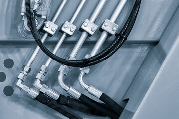 Poster - Machine hydraulic or pneumatic with pipes in a row connected to each other. Pipes black and silver. Industrial concept.