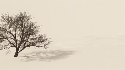 A solitary tree stands starkly against a barren winter landscape