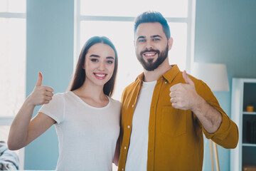 Canvas Print - Photo of two young partners show thumb up free time modern interior apartment indoors