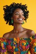 © Lubos Chlubny - Young black woman with curly hair is smiling on a yellow background
