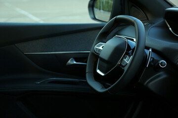 Wall Mural - Steering wheel and dashboard inside of modern luxury car, closeup. Space for text