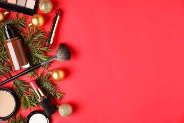 Poster - Flat lay composition with makeup products and Christmas decor on red background, space for text