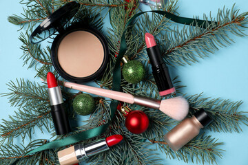 Poster - Makeup products and Christmas decor on light blue background top view