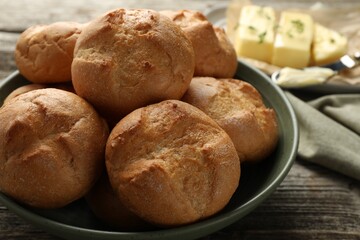 Poster - Homemade tasty buns in bowl on wooden table, closeup