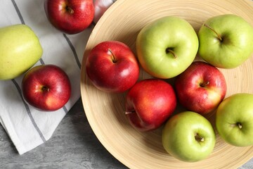 Fresh red and green apples on grey table, flat lay