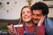 © CarlosBarquero - Cheerful smiling young Caucasian couple looking at positive pregnancy test result. Joyful people in love celebrating together with predictor in hand. Happy future millennial family expecting a baby