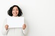 © Ben Trobat - Smiling woman holding blank paper on white background