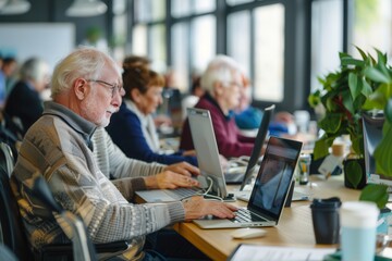 Leinwandbilder - A group of elderly learners engages in computer training, working diligently on laptops in a sunny classroom setting. Generative AI