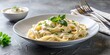 © Hugnaka - Creamy white sauce pasta served in stylish dining atmosphere