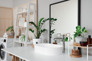 Wall Mural - Modern sink, houseplants and cosmetic products on white table in bathroom