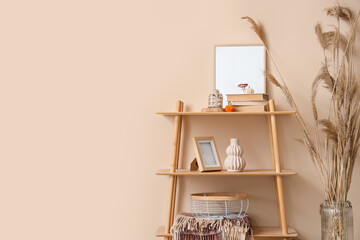 Wall Mural - Shelf unit and vase with dry reeds near beige wall in room