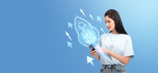 Poster - Woman interacting with holographic rocket icon on her smartphone